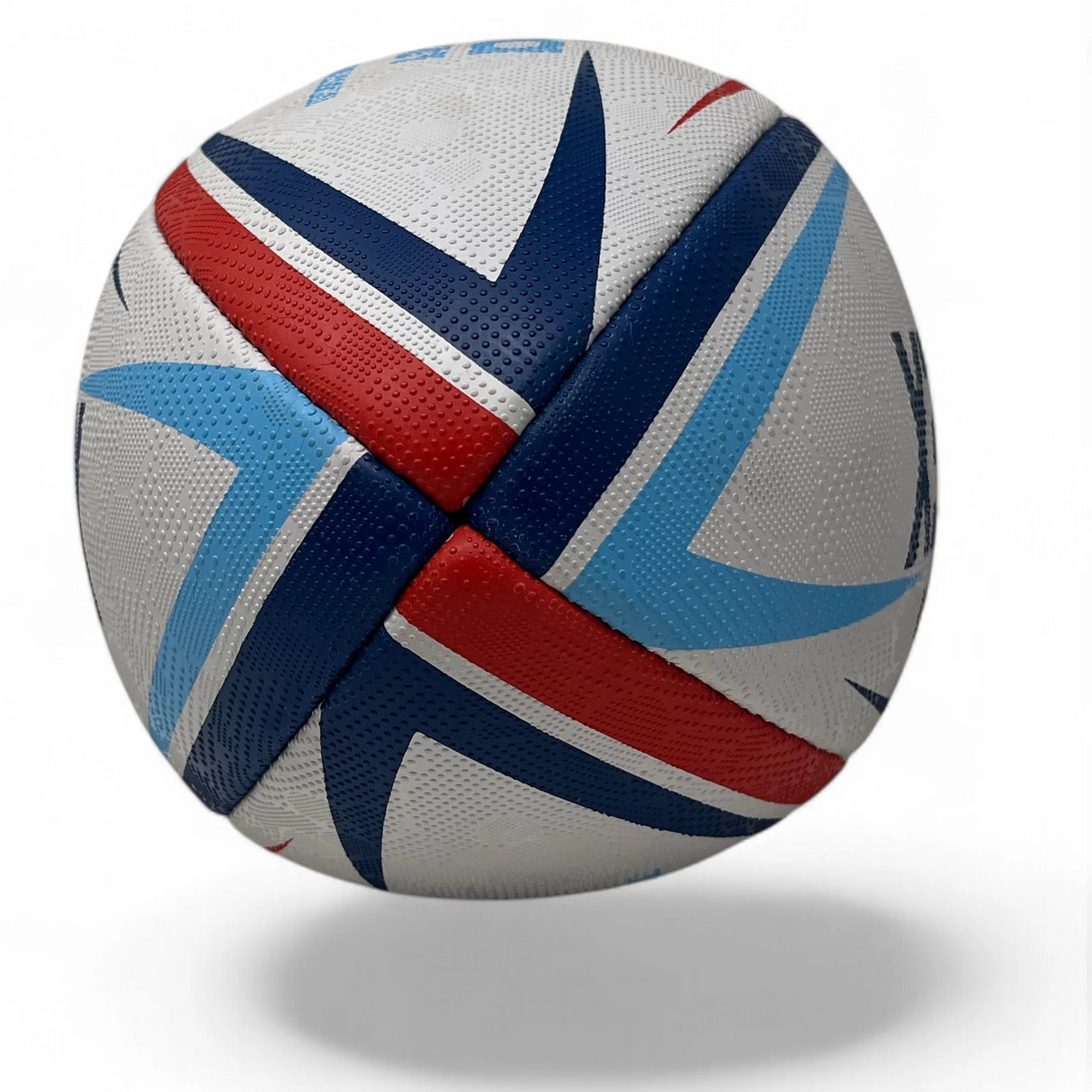 Ruggers Rugby Supply KooGa practice rugby ball with white, red, and blue geometric grip pattern on a white background