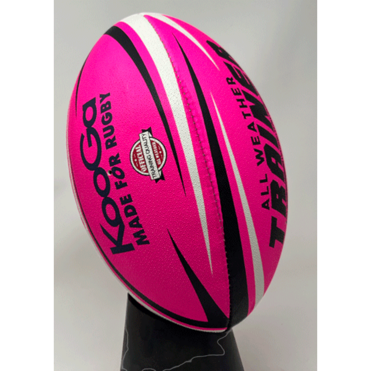 Ruggers Rugby Supply KooGa high-visibility pink training rugby ball with black and white accents on a stand