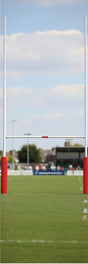 Ruggers Rugby Supply 6-foot tall red protective foam goal post pads on a rugby field